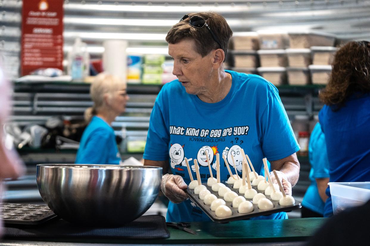 Carole Schlapkohl, volunteering for the Iowa Egg Council, hands out free boiled eggs to fairgoers.