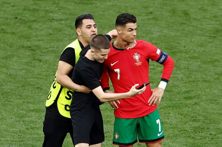 Several pitch invaders tried to take selfies with Cristiano Ronaldo during the win over Turkey on Saturday (KENZO TRIBOUILLARD)