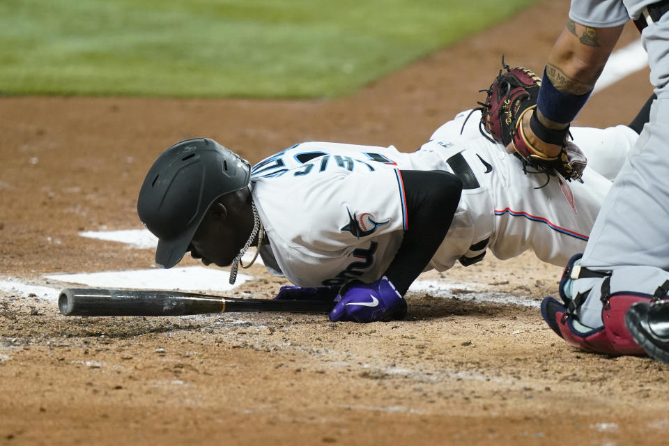 Miami Marlins' Jazz Chisholm Jr. falls to the ground as he moves away from a close pitch thrown by St. Louis Cardinals starting pitcher Jordan Hicks during the third inning of a baseball game, Thursday, April 21, 2022, in Miami. (AP Photo/Lynne Sladky)