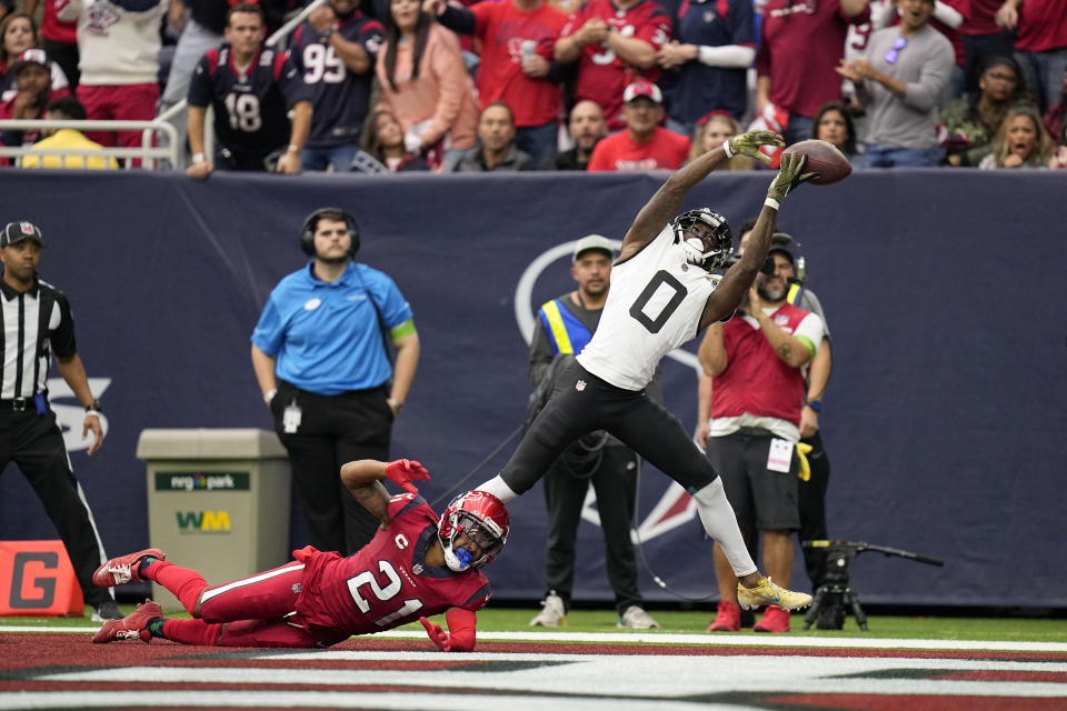 Jacksonville Jaguars wide receiver Calvin Ridley (0) is unable to reach a pass in the end zone as Houston Texans cornerback Steven Nelson (21) defends in the first half of an NFL football game in Houston, Sunday, Nov. 26, 2023. (AP Photo/Eric Gay)