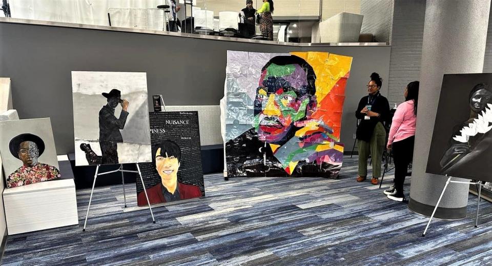 Attendees look at artwork on display at Metro Tech's 2023 Black History Month Celebration.