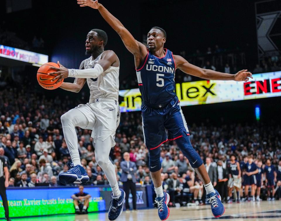Xavier Musketeers guard Souley Boum (0) drives the hoop around Connecticut Huskies guard Hassan Diarra (5) in the second half Saturday, December 31, 2022 at the Cintas Center. Xavier won 83-73.