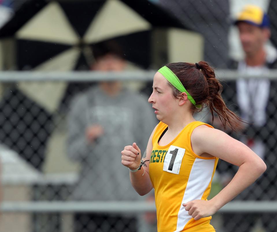 Firestone's Ella Julien competes in the girls 1,600 meters during the City Series track meet at Ellet High School on Saturday.