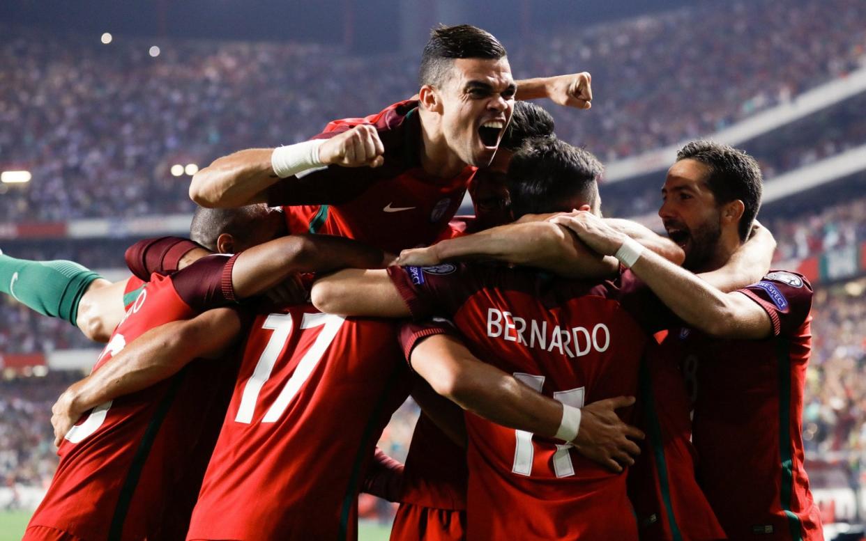 Portugal players celebrate during their 2-0 defeat of Switzerland in Lisbon, a result that saw the European champions qualify for next summer's World Cup finals in Russia - LUSA