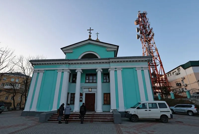 A view shows a communication tower next to an Orthodox church in Vladivostok