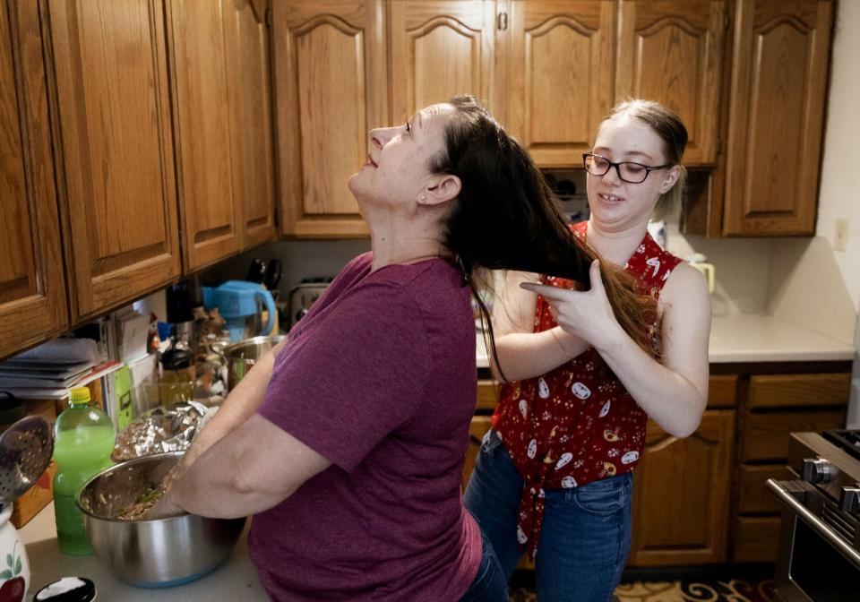 Cassie McIff holds back her mother Martha’s hair as they make stuffed peppers for dinner in Orem on Thursday, July 6, 2023. | Laura Seitz, Deseret News