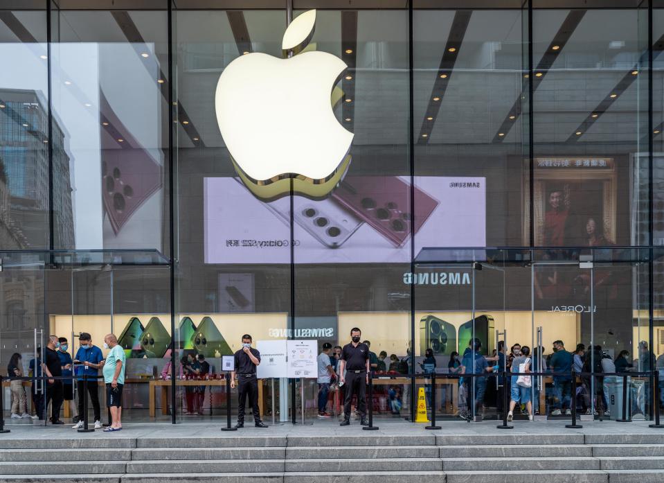 File: People visit an Apple Store in Shanghai on 10 June 2022 (AFP via Getty Images)