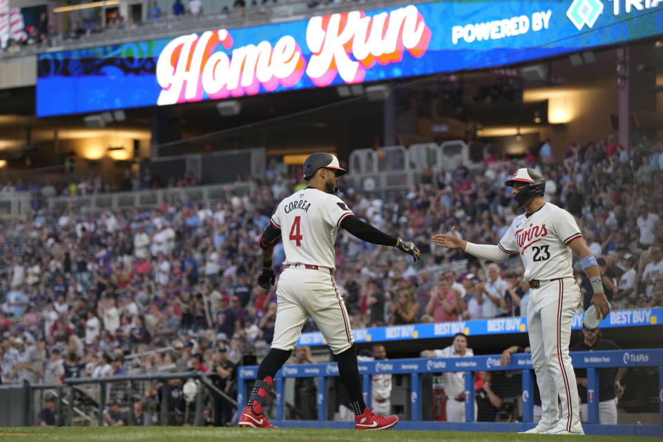 Minnesota Twins' Carlos Correa (4) celebrates with Royce Lewis (23) after hitting a two-run home run against the Oakland Athletics during the seventh inning of a baseball game Thursday, June 13, 2024, in Minneapolis. (AP Photo/Abbie Parr)