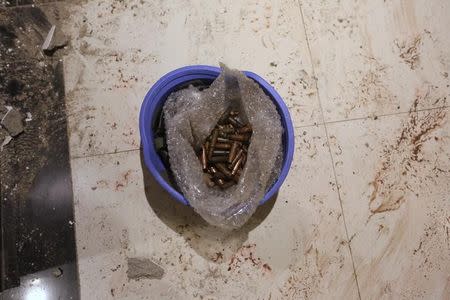 Bullet casings are seen in a helmet on the floor of the Radisson hotel in Bamako, Mali, November 20, 2015. REUTERS/Joe Penney