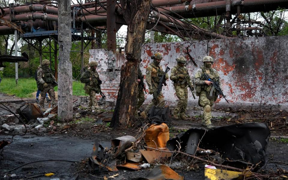 Russian troops on patrol at the steelworks in Mariupol where there are said to be at least 1,000 Ukrainian soldiers still hiding in its web of tunnels - AP