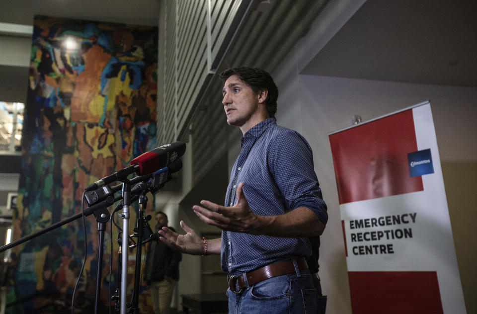 Prime Minister Justin Trudeau speaks about the wildfires in British Columbia and the Northwest Territories after visiting evacuees in Edmonton, Alberta, Friday, Aug. 18, 2023.(Jason Franson/The Canadian Press via AP)