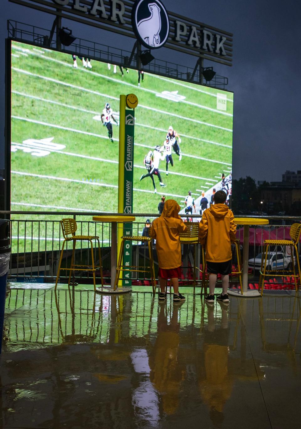 It's a rainout at Polar Park, but brothers Andrew and Brady Sharr from Auburn watch preseason Patriots action on the big screen Thursday.