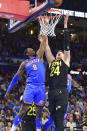 Utah Jazz center Walker Kessler (24) and Oklahoma City Thunder forward Jalen Williams (8) reach for a rebound during the second half of an NBA basketball game Wednesday, March 20, 2024, in Oklahoma City. (AP Photo/Kyle Phillips)