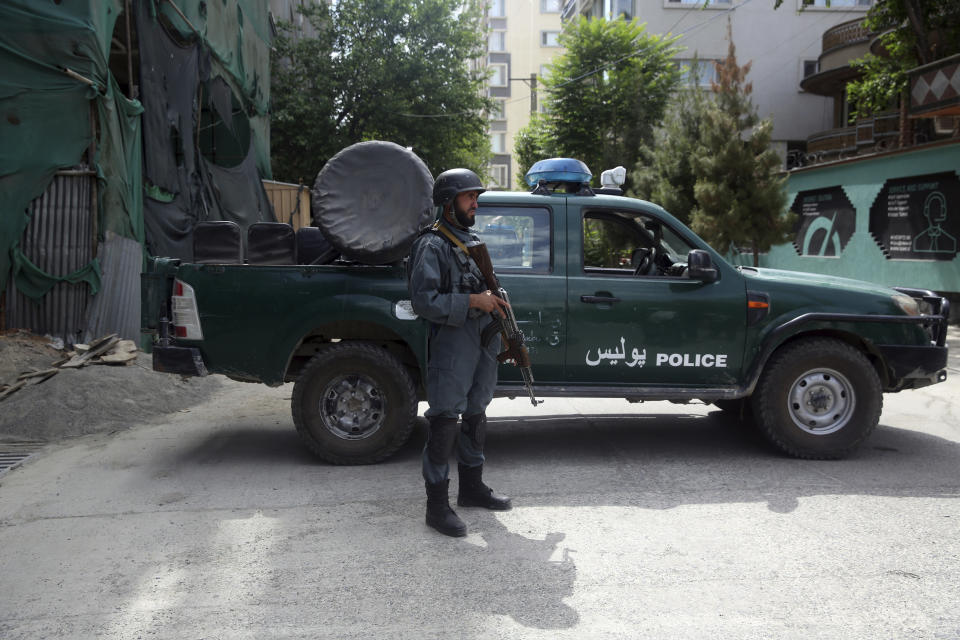 An Afghan police stand guards near to the mosque following a bombing, in Kabul, Afghanistan, Friday, June 12, 2020. (AP Photo/Rahmat Gul)