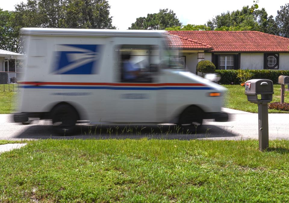 A U.S. Postal Service truck passes several mailboxes while out making deliveries on a residential street on the Treasure Coast Thursday, Aug. 4, 2023.