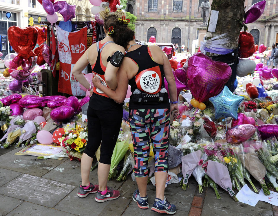 Runners standing at flower tribute