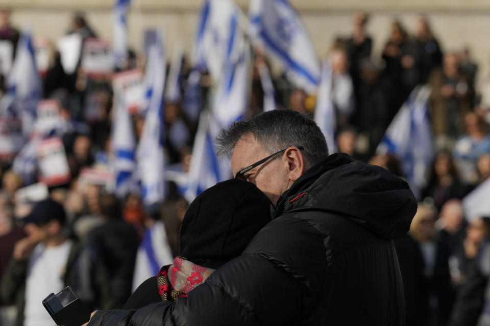 A couple embrace during a protest in Trafalgar Square, London, Sunday, Oct. 22, 2023. They are demanding the release of all hostages allegedly taken by the militant group Hamas. (AP Photo/Frank Augstein)