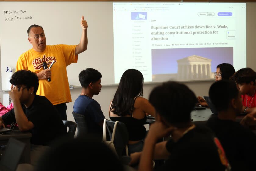 LOS ANGELES, CA - SEPTEMBER 15, 2022 - - Roosevelt High School 12th grade government teacher Aldo Parral uses the News Literacy Project's materials to teach his students about how to read the news and sniff out what's true and what's not in Los Angeles on September 15, 2022. A growing trend in American education is teaching "news literacy." Students need to know where and how to look for real and verifiable news sources and stories. Some schools in the L.A. Unified School District are beginning to incorporate curriculum offered by the News Literacy Project NLP which was founded by former LA Times reporter and Pulitzer Prize winner Alan Miller. It is now being used in hundreds of schools across the U.S. Melanie Lundquist, who is giving a $10 million gift to News Literacy Project, recently visited the classroom with Miller and LAUSD Superintendent Alberto M. Carvalho. (Genaro Molina / Los Angeles Times)