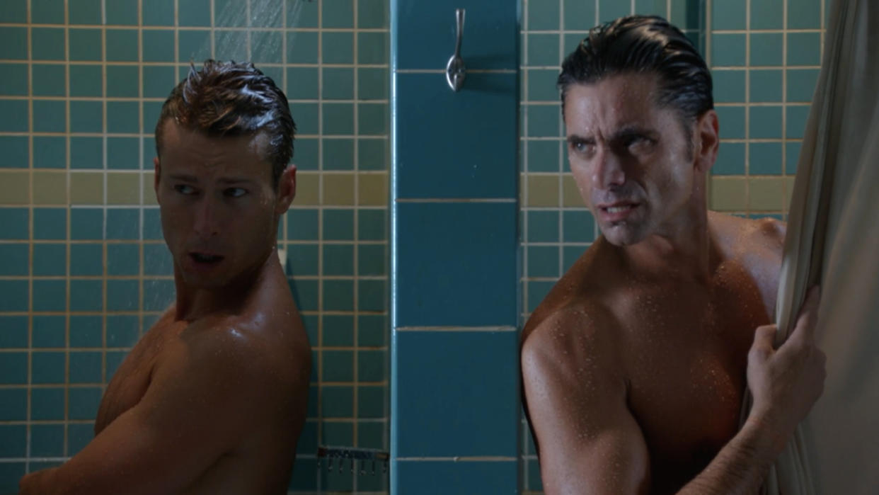  Glen Powell and John Stamos talking in the shower in Scream Queens. 