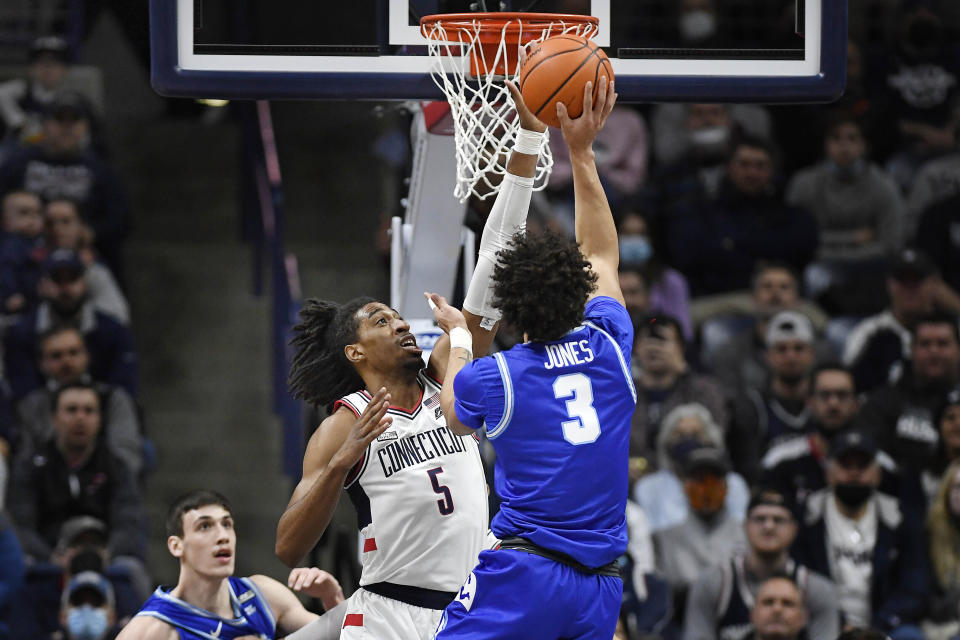 Connecticut's Isaiah Whaley blocks a shot by Xavier's Colby Jones (3) in the first half of an NCAA college basketball game, Saturday, Feb. 19, 2022, in Storrs, Conn. (AP Photo/Jessica Hill)