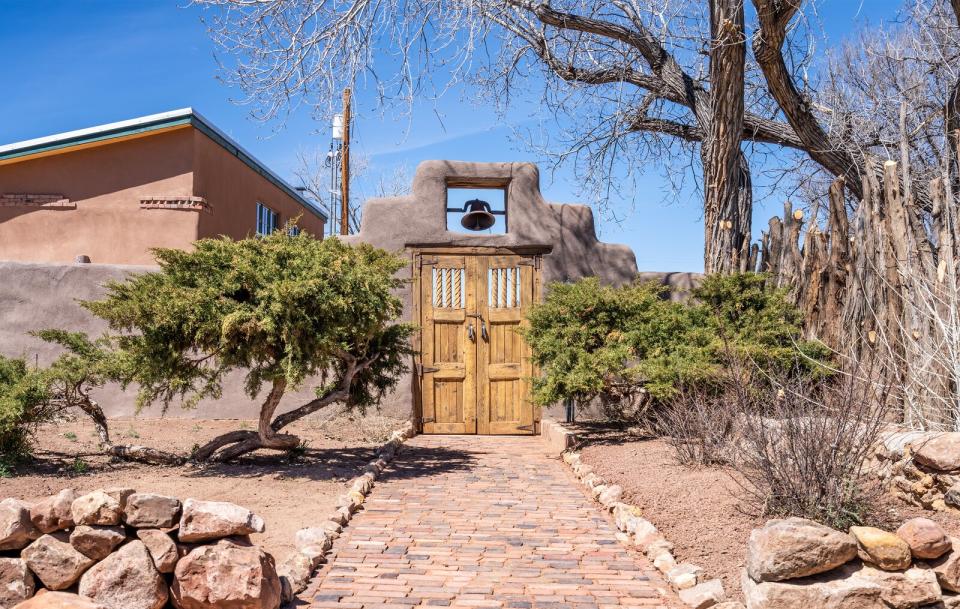 A tall, adobe-style wall borders the landmark home, ensuring plenty of peace and privacy.