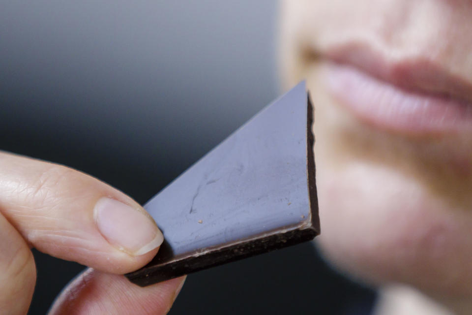 BERLIN, GERMANY - APRIL 13: Symbolic photograph. A woman eats a piece of chocolate on April 13, 2020 in Berlin, Germany. (Photo by Thomas Trutschel/Photothek via Getty Images)