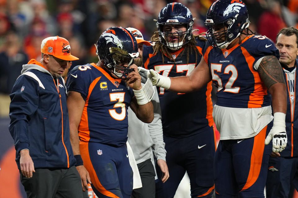 Denver Broncos quarterback Russell Wilson (3) is helped off the field during the second half of an NFL football game against the Kansas City Chiefs Sunday, Dec. 11, 2022, in Denver. (AP Photo/Jack Dempsey)