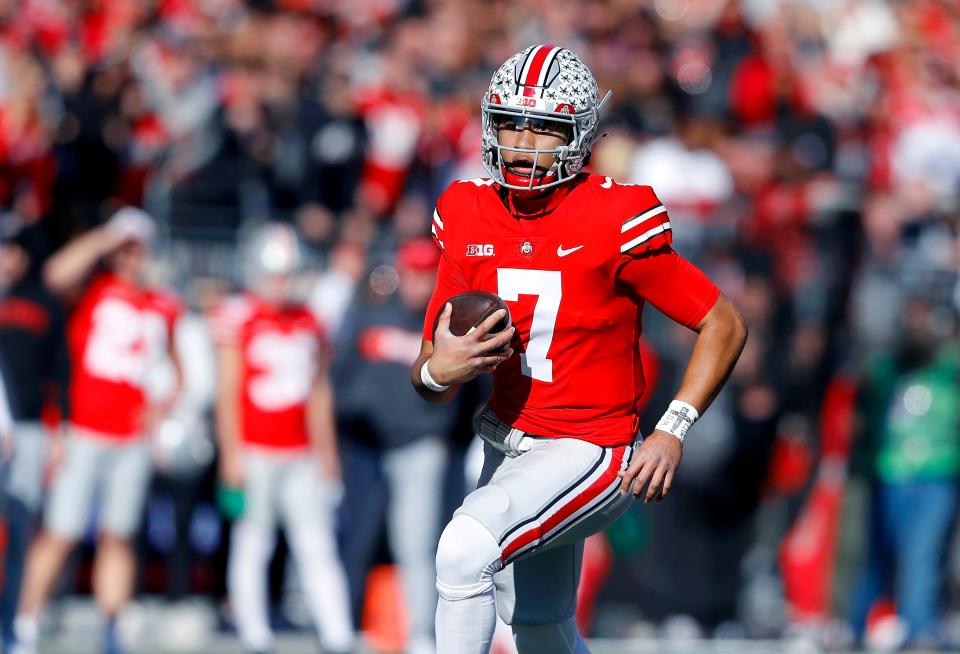 Nov 26, 2022; Columbus, Ohio, USA; Ohio State Buckeyes quarterback C.J. Stroud (7) runs past the Michigan Wolverines defense during the first quarter at Ohio Stadium.