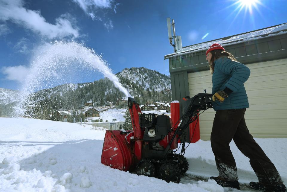 Elizabeth McDonald clears the newly fallen snow at Hellgate Condominiums in Little Cottonwood Canyon on Thursday, Oct. 26, 2023. | Jeffrey D. Allred, Deseret News
