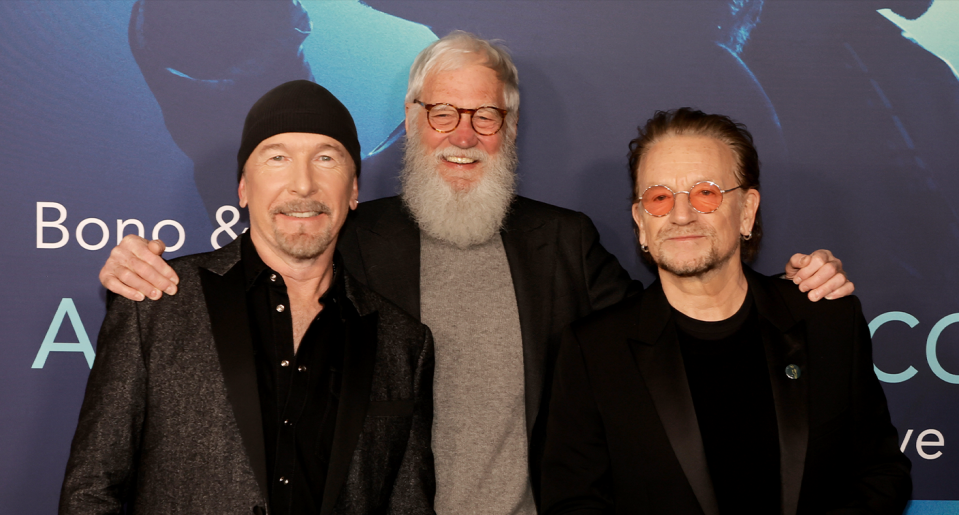 U2's The Edge and Bono with their friend, fan, and 'Bono & The Edge: A Sort of Homecoming with Dave Letterman' co-star. (Photo: Getty Images)