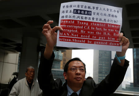 A man protests outside the High Court before the arrival of former Hong Kong Chief Executive Donald Tsang, in Hong Kong, China February 20, 2017. REUTERS/Bobby Yip