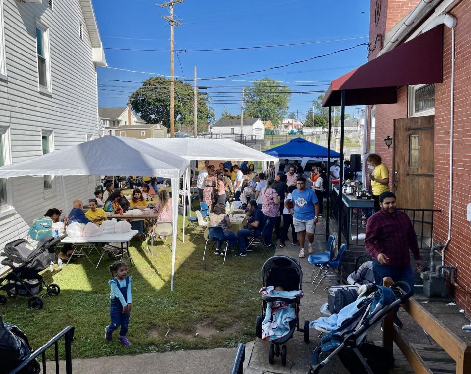 Archangel Michael and St. Karas Coptic Orthodox Church members, worshipping in Dallastown for five years, have established a popular annual food festival. Here, congregants enjoy the fare and fellowship at their South Charles Street church building, the former Trinity United Methodist Church.