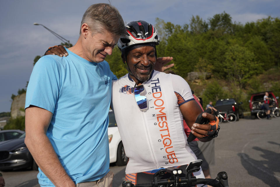 Steve Milligan, left, and cyclist Paul Trice remember Milligan's daughter, Alyssa, before a memorial ride in her honor Tuesday, Sept. 12, 2023, in Mount Juliet, Tenn. Milligan's daughter was struck and killed by a pickup truck while cycling with a friend the previous week. (AP Photo/George Walker IV)