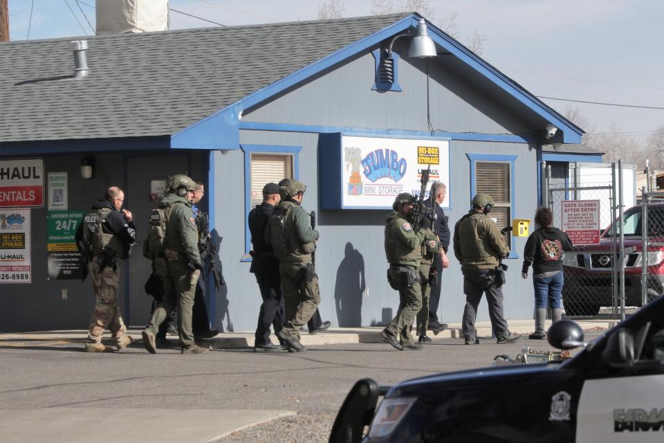 Members of the Farmington Police Department SWAT team prepare to search Jumbo's Mini Storage at 908 N. Tucker Ave. on Jan. 8 for suspect Elias Buck