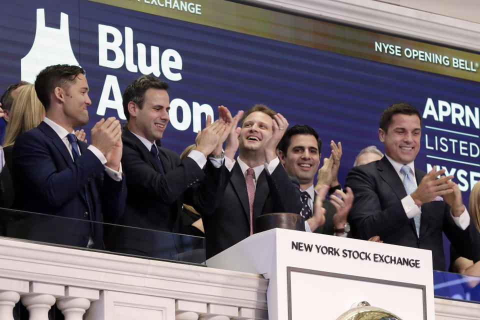 Blue Apron CEO Matt Salzberg, center, joins applause with fellow company co-founders Matt Wadiak, second left, and Ilia Papas, second from right, during opening bell ceremonies of the New York Stock Exchange before their IPO begins trading, Thursday, June 29, 2017. NYSE President Tom Farley is at right. (AP Photo/Richard Drew)