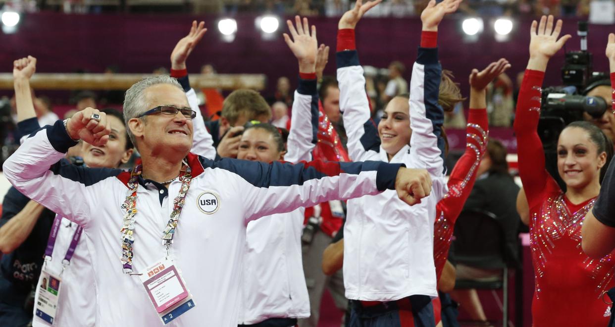 Geddert celebrates with USA Gymnastics team after the U.S. won gold for the artistic gymnastics event during the London games on July 31, 2012.&nbsp; (Photo: THOMAS COEX via Getty Images)