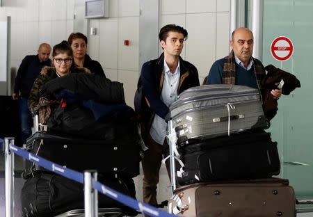 Fuad Sharef Suleman and his family push their belongings after returning to Iraq from Egypt, where they were prevented from boarding a plane to the U.S., following U.S. President Donald Trump's decision to temporarily bar travellers from seven countries, including Iraq, at Erbil International Airport, Iraq, January 29, 2017. REUTERS/Ahmed Saad