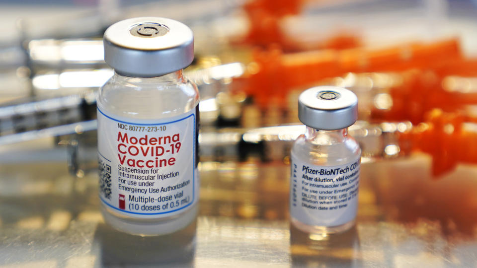 Vials for the Moderna and Pfizer COVID-19 vaccines are displayed on a tray at a clinic set up by the New Hampshire National Guard in the parking lot of Exeter, N.H., High School, Thursday, Feb. 25, 2021, in Exeter. The temporary facility, operating out of a field hospital tent, administers both the Moderna and Pfizer COVID-19 vaccines. (AP Photo/Charles Krupa)