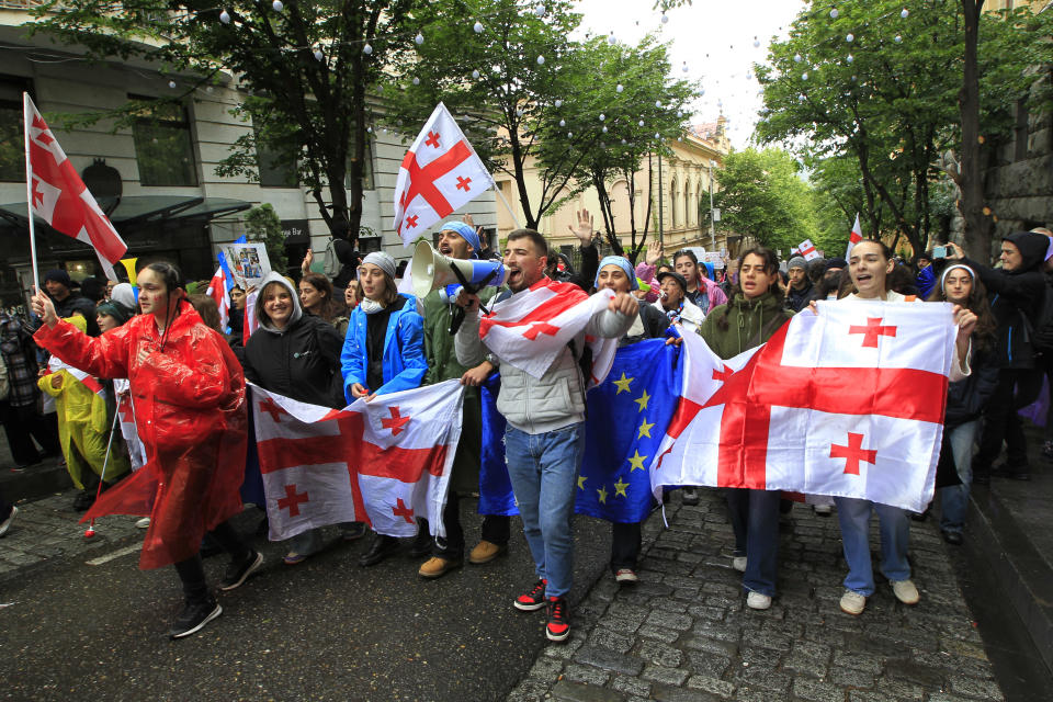 Demonstrators attend an opposition protest against "the Russian law" near the Parliament building in the center of Tbilisi, Georgia, Tuesday, May 14, 2024. Georgia's parliament on Tuesday began the third and final reading of a divisive bill that sparked weeks of mass protests, with critics seeing it as a threat to democratic freedoms and the country's aspirations to join the European Union. (AP Photo/Shakh Aivazov)