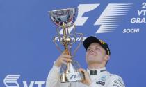 Formula One - F1 - Russian Grand Prix - Sochi, Russia - 30/04/17 - Winner and Mercedes Formula One driver Valtteri Bottas of Finland holds the trophy on the podium. REUTERS/Maxim Shemetov