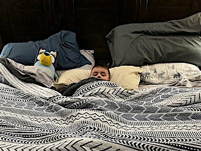 Bethaney Phillips' younger son tucked into bed.