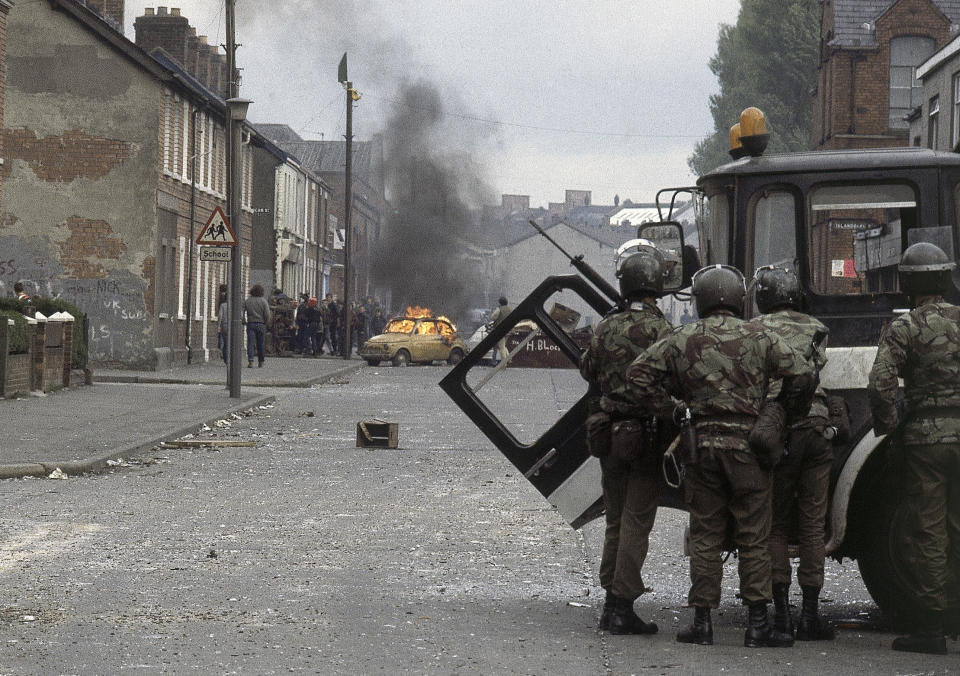 FILE - British troops, in foreground, clash with demonstrators in a Catholic dominated area of Belfast, Northern Ireland on May 5, 1981. As King Charles III arrived in Northern Ireland for the first visit since his mother’s death elevated him to the throne, the voices of Belfast offered a sharp reminder of the country’s complicated bloody political realities. (AP Photo, File)