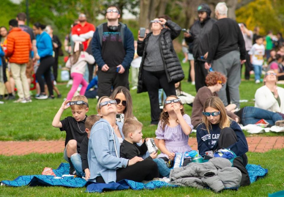 People watch during a solar eclipse Monday, April 08, 2024 at Grundy Library in Bristol, Pennsylvania. In the Philadelphia area, only 90% of the sun will be covered by the moon’s shadow. (Photo by William Thomas Cain)