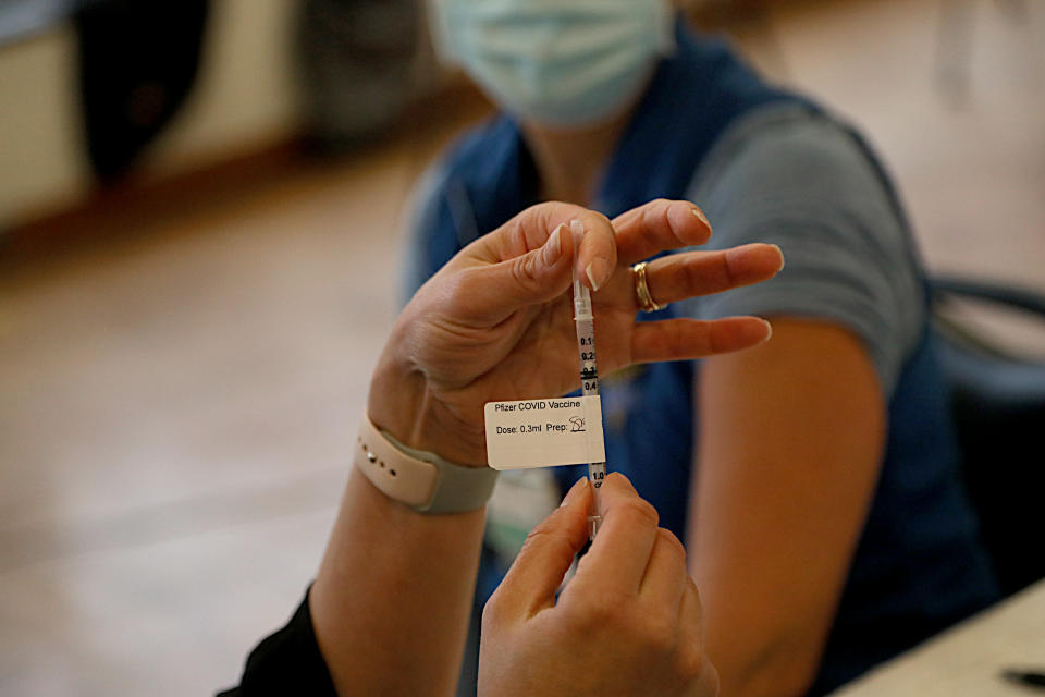 A Pfizer COVID-19 vaccine is prepared at Rhode Island Hospital in Providence. (Suzanne Kreiter/The Boston Globe via Getty Images)