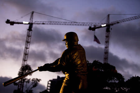 FILE PHOTO: A bronze statue of former San Diego Padres outfielder Tony Gwynn is seen as fans mourn his death, at Petco Park in San Diego, California June 16, 2014. Gwynn, one of the greatest hitters of his generation, died on Monday at age 54 after a battle with cancer, the National Baseball Hall of Fame and Museum said. REUTERS/Sam Hodgson