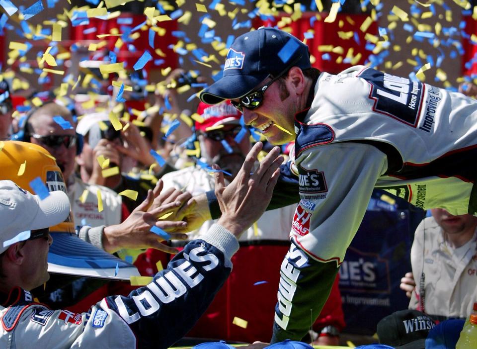 jimmie johnson shakes his crews hands after winning the winston cup napa auto parts 500 at the calif