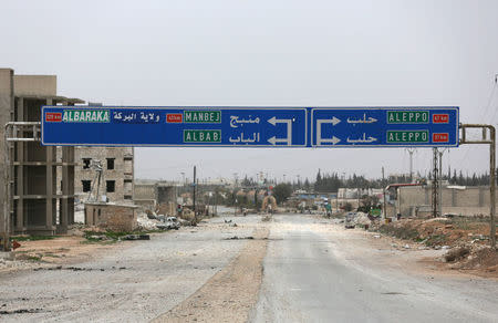 A road sign that shows the direction to Manbij city is seen in the northern Syrian town of al-Bab, Syria March 1, 2017. REUTERS/Khalil Ashawi