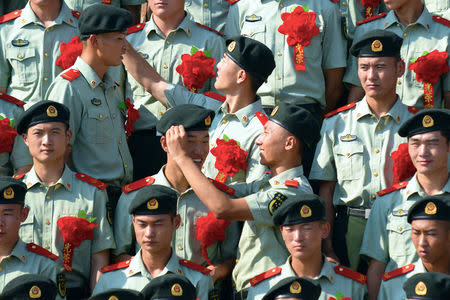 Retiring paramilitary policemen prepare for a group photo before retirement in Nanjing, Jiangsu province, China, August 29, 2017. REUTERS/Stringer