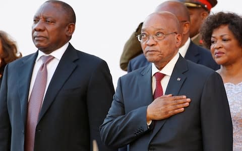 South Africa's President Cyril Ramaphosa, standing next to Jacob Zuma, has pledged to stamp out corruption - Credit: REUTERS/Mike Hutchings
