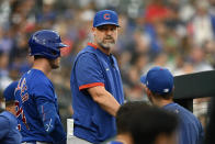 Chicago Cubs manager David Ross, center, looks into the dugout in the third inning of a baseball game against the Detroit Tigers, Monday, Aug. 21, 2023, in Detroit. (AP Photo/Jose Juarez)